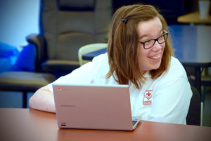 Emily using assistive technology at the Academy